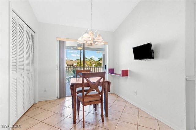 dining space featuring light tile patterned floors, lofted ceiling, and an inviting chandelier