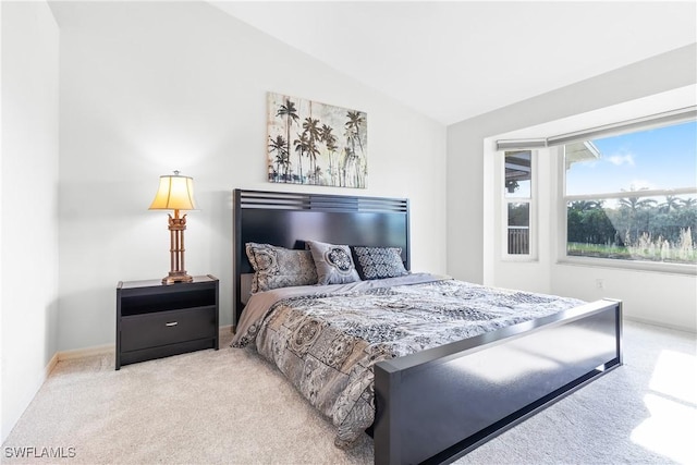 carpeted bedroom featuring lofted ceiling