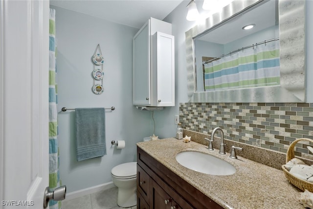 bathroom with toilet, vanity, backsplash, and tile patterned floors