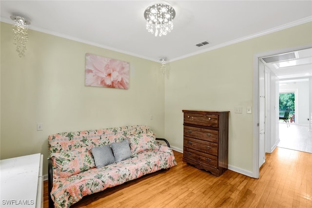 living area with ornamental molding and hardwood / wood-style flooring