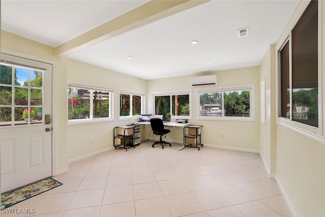 office featuring plenty of natural light, light tile patterned floors, and a wall unit AC