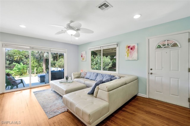 living room featuring ceiling fan and wood-type flooring