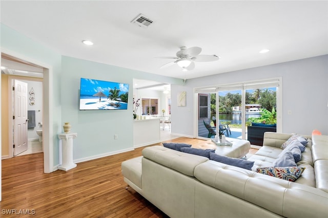 living room with ceiling fan and hardwood / wood-style floors