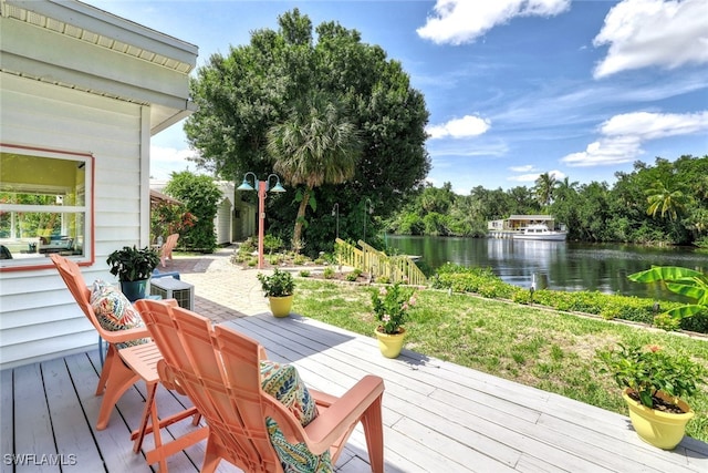 wooden terrace featuring a water view