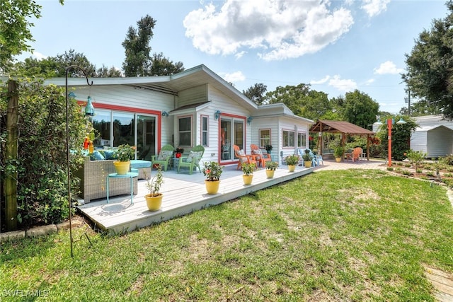 back of house with a yard and a deck