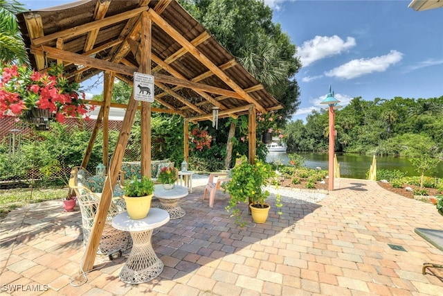 view of patio / terrace featuring a gazebo and a water view