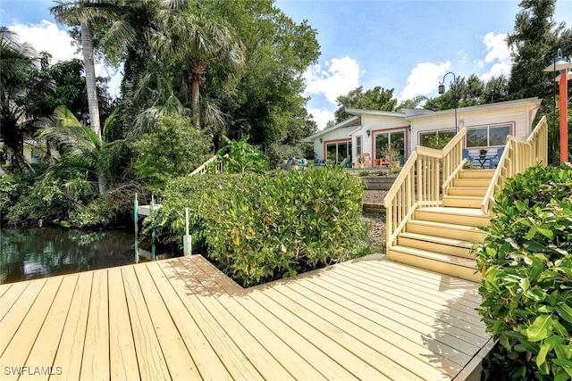 wooden terrace featuring a water view