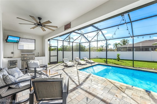 view of pool with outdoor lounge area, grilling area, an outdoor kitchen, a lanai, and a patio