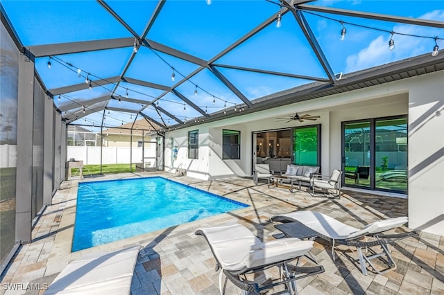 view of swimming pool featuring outdoor lounge area, pool water feature, ceiling fan, a lanai, and a patio area