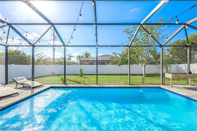 view of swimming pool with a patio, glass enclosure, and a lawn