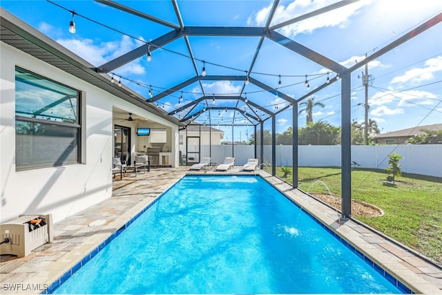 view of pool featuring a lanai, a yard, and a patio