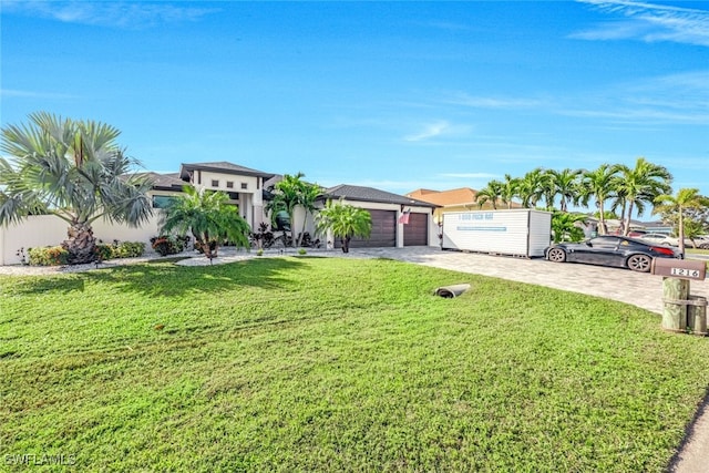 ranch-style house featuring a garage and a front yard