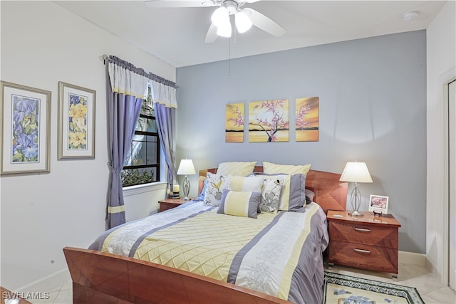 bedroom with ceiling fan and light tile patterned flooring