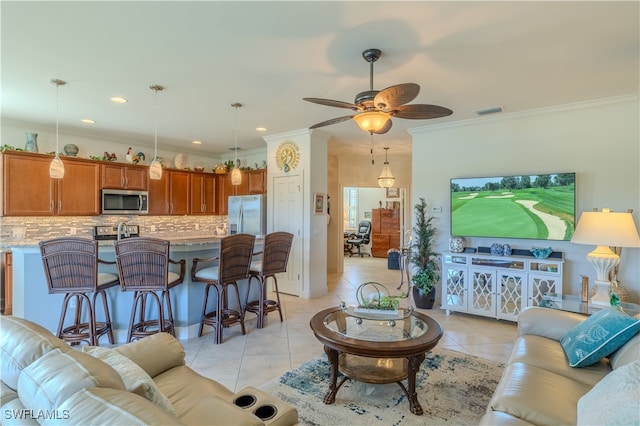 tiled living room with ceiling fan and ornamental molding