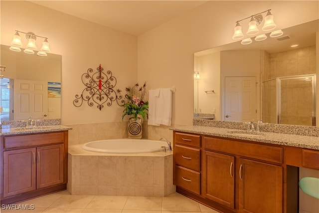 bathroom with tile patterned floors, vanity, and shower with separate bathtub