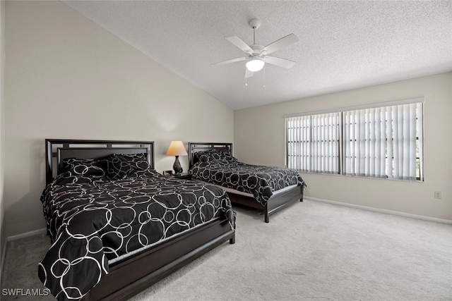 bedroom with ceiling fan, a textured ceiling, carpet flooring, and vaulted ceiling