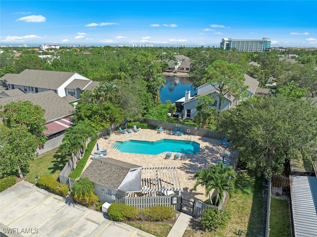 view of pool featuring a patio and a water view