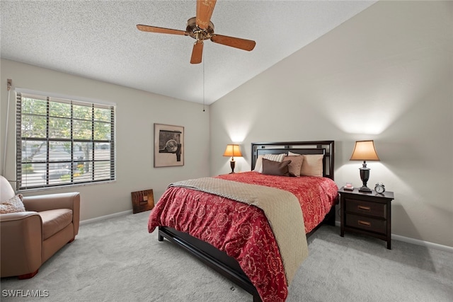 carpeted bedroom featuring ceiling fan, a textured ceiling, and vaulted ceiling