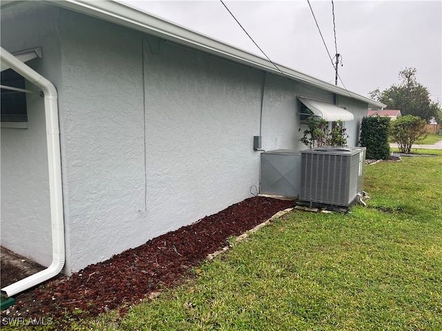 view of property exterior featuring cooling unit and a lawn