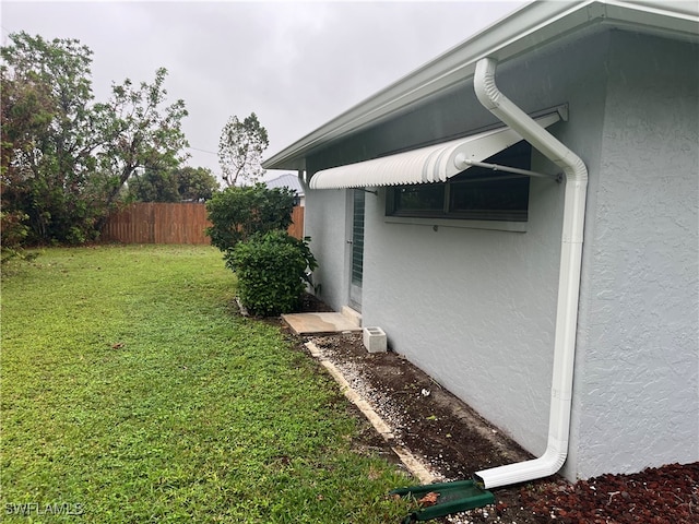 view of side of property with a lawn