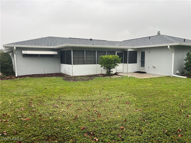 back of house with a sunroom and a yard