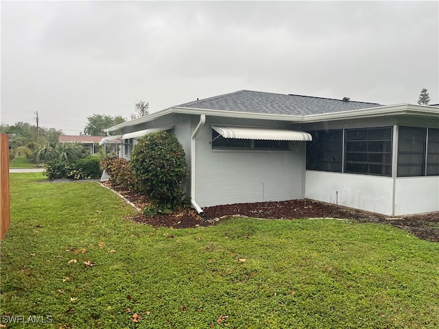 view of side of property featuring a yard