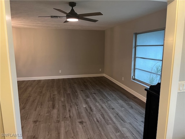 spare room featuring a textured ceiling, ceiling fan, and dark hardwood / wood-style floors