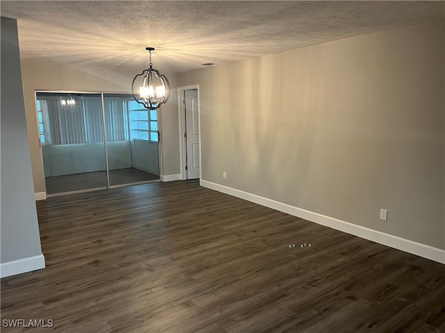 unfurnished room featuring dark hardwood / wood-style flooring and a textured ceiling