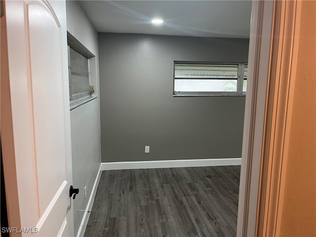 unfurnished room with dark hardwood / wood-style flooring