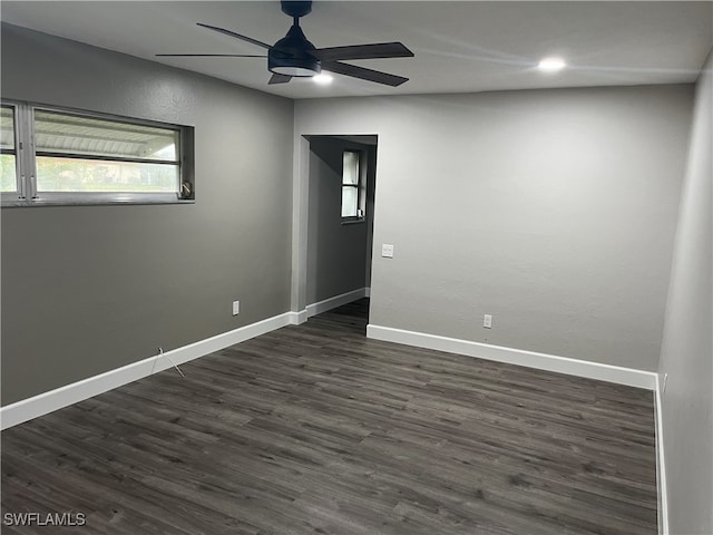 empty room with ceiling fan and dark hardwood / wood-style floors