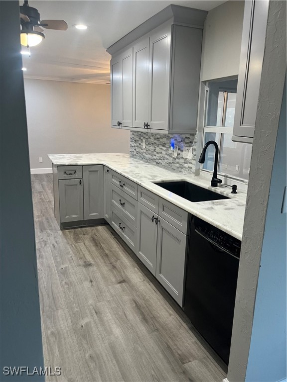 kitchen featuring gray cabinetry, sink, and black dishwasher