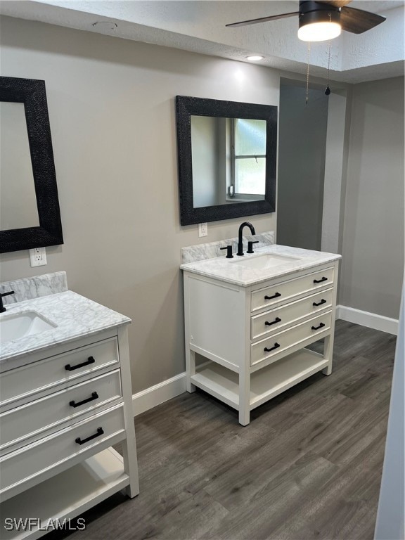 bathroom featuring ceiling fan, vanity, and wood-type flooring