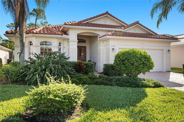 mediterranean / spanish-style home with a front lawn