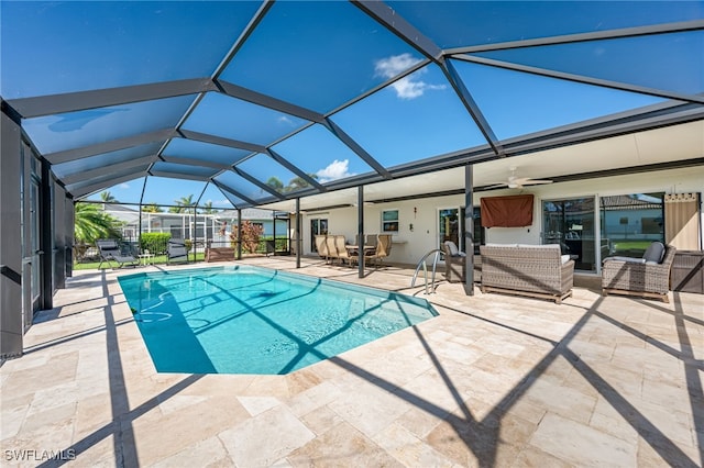 view of pool with ceiling fan, a patio area, and a lanai