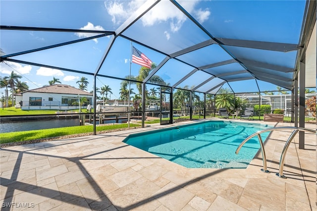 view of swimming pool with glass enclosure, a water view, and a patio