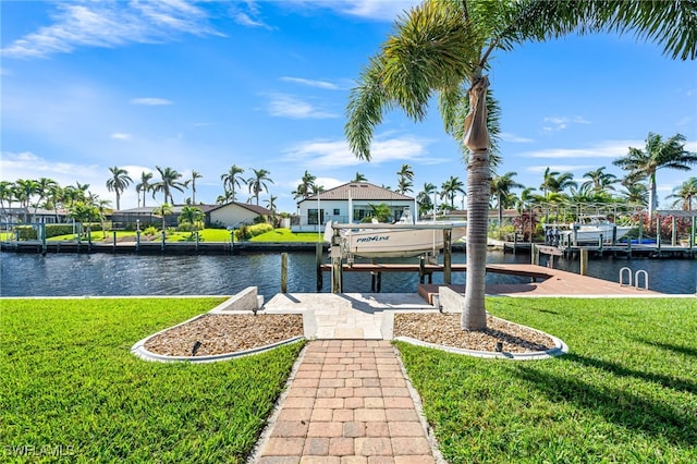 view of dock featuring a yard and a water view