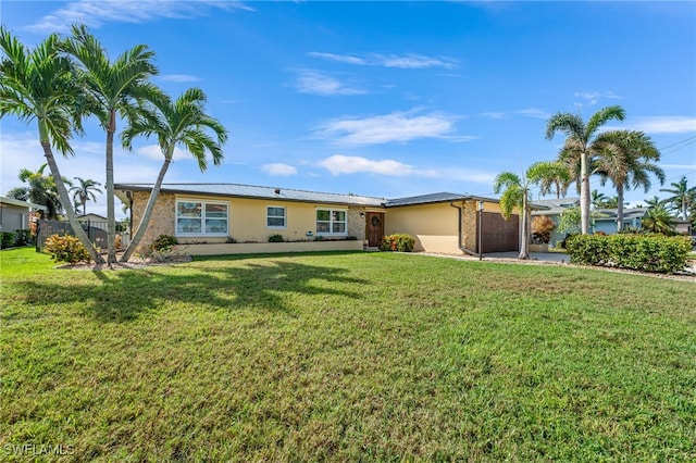 ranch-style house with a garage and a front lawn