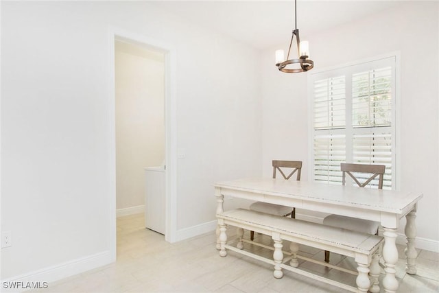 dining area with baseboards and a chandelier