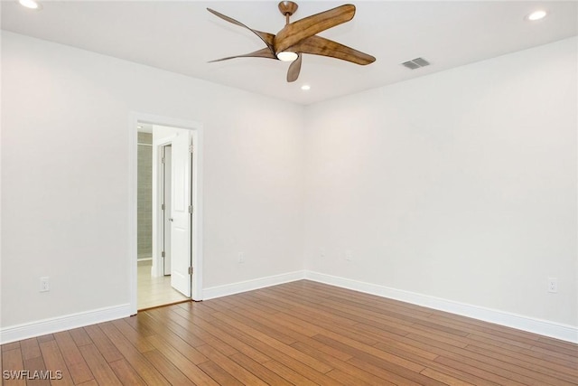 unfurnished room with recessed lighting, visible vents, baseboards, and wood finished floors