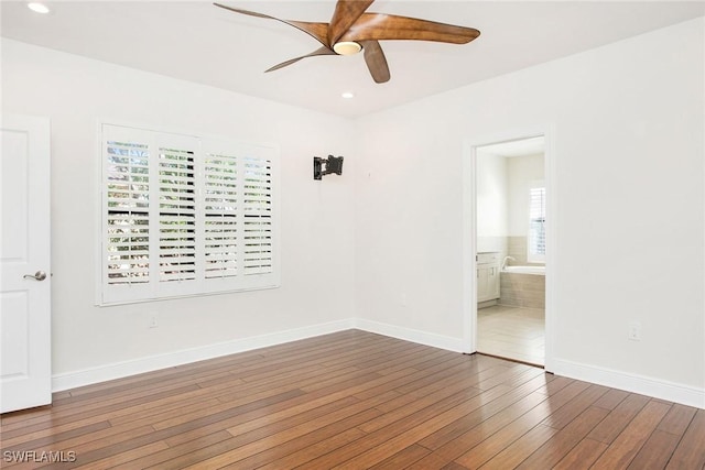 spare room with recessed lighting, dark wood finished floors, a ceiling fan, and baseboards