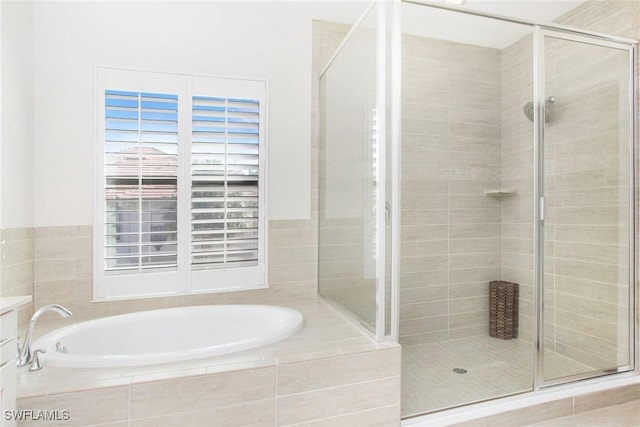 full bathroom with a stall shower and a garden tub