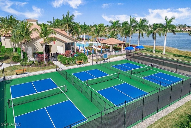 view of sport court with a water view, fence, and a gazebo