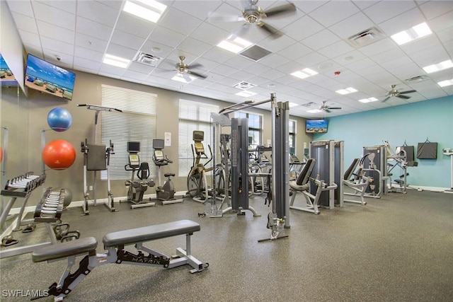 gym featuring visible vents, a drop ceiling, and a ceiling fan