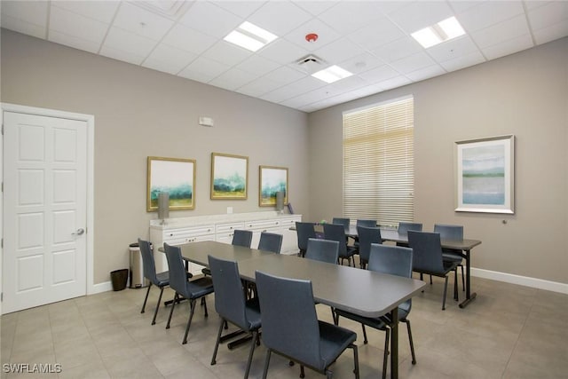 dining area featuring a drop ceiling, visible vents, and baseboards