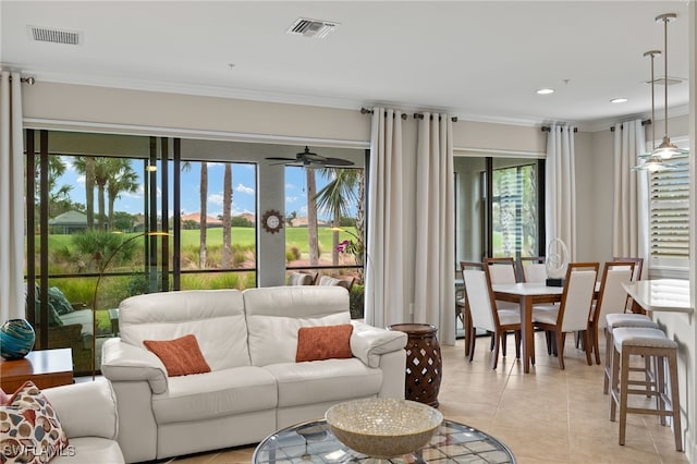 living room with ceiling fan, light tile patterned floors, and crown molding