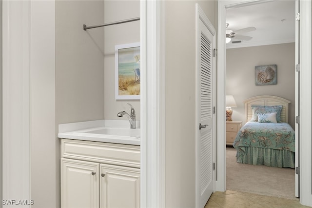 bathroom featuring tile patterned floors, vanity, ceiling fan, and ornamental molding