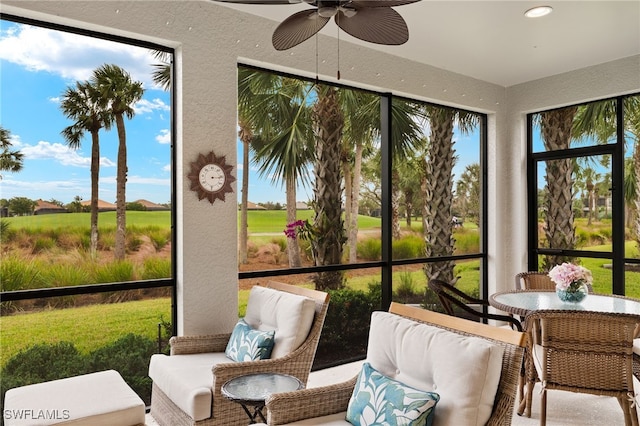 sunroom featuring ceiling fan