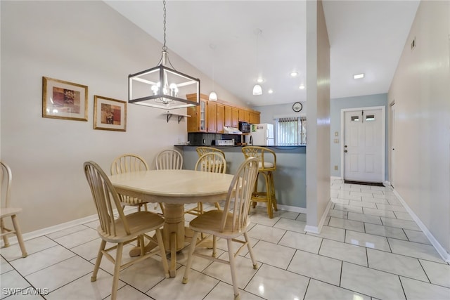 dining area with light tile patterned floors, vaulted ceiling, and a notable chandelier