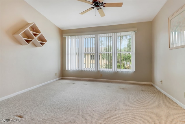 carpeted spare room with ceiling fan