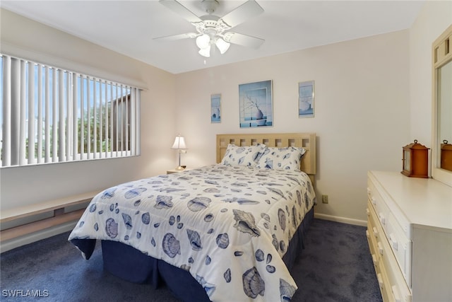 bedroom with ceiling fan and dark colored carpet